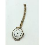 9ct Gold ladies wristwatch with enamel dial (glass vacant) on a 9ct gold marked strap 19g gross