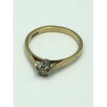 9ct Gold single stone diamond ring with central illusion set yellowish/brown diamond