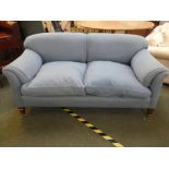 A good, blue upholstered sofa on mahogany legs to castors, stamped to inside back leg, Howard