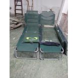 Two outdoor folding sun loungers with cushions