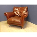 Leather armchair in burgundy, castors to front legs 84H x 94W x 93D cm