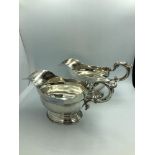Pair of Georgian style silver pedestal oval sauce boats with molded scroll handles, by Lambert &