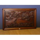 A framed wood panel decorated with a dragon and fish carving 57H x 92W cm