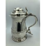 Large George II silver baluster tankard, domed lid with chair back thumb piece, scrolling handle