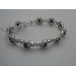 Silver cubic zirconia & blue topaz line bracelet made up of 10 links