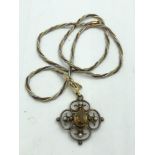 9ct Gold openwork pendant set with central free cut stone with pearl accents on a yellow metal chain