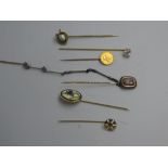 Collection of gold, yellow & white metal tie pins