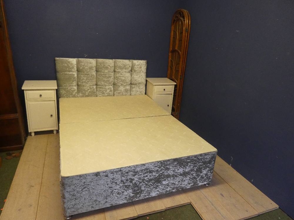 A double bed, headboard, a screen and two bedside tables