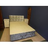 A double bed, headboard, a screen and two bedside tables