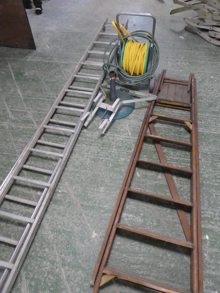A quantity of outdoor items to include two ladders, a hose on reel umbrella stand etc.
