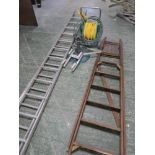 A quantity of outdoor items to include two ladders, a hose on reel umbrella stand etc.