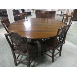 A circular, oak , pedestal dining table & 6 solid seat splat back chairs