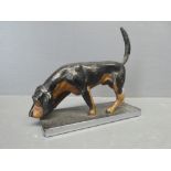 A car mascot in the form of a Black & tan fox hound