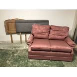 Small two seater sofa with pink covers, and two headboards