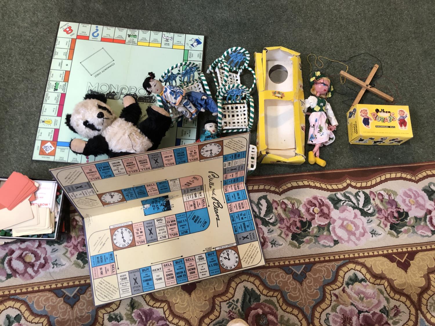 Two Pelham Puppetts, and other toys to include Monopoly, panda, china doll etc