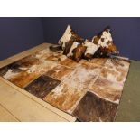Qty of cowhide style rugs & cushions