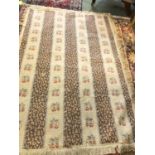 2 modern rugs, one a cream knotted rug (185 x 120), and another beige ground (215 x 144)