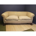 A Large cream upholstered sofa, raised on large carved paw feet 234L x 87H x 120D cm