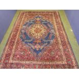 Red ground rug, with blue central oval medallion, and cream frame borders 360L x 253W cm