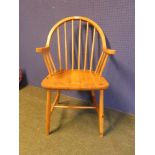 A light wood stick back, Windsor style arm chair 90H x 51W cm