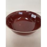 Chinese dark red/brown ceramic circular bowl, with an internal crazed grey base to the inverted rim,