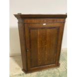 Good quality George III mahogany hanging oak corner cupboard with cross banded door and fitted
