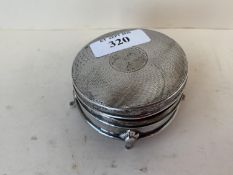 Circular silver trinket box with blue lined interior on 4 raised feet