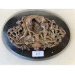 Bronze relief plaque over oval wooden stand, 24cm L CONDITION: General wear to the stand