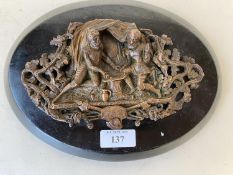 Bronze relief plaque over oval wooden stand, 24cm L CONDITION: General wear to the stand