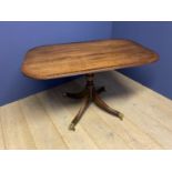 Regency style crossbanded mahogany pedestal breakfast table, swept legs to brass castors, 128 x 81 .
