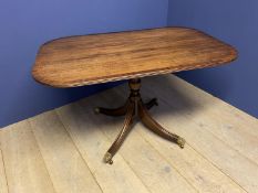 Regency style crossbanded mahogany pedestal breakfast table, swept legs to brass castors, 128 x 81 .