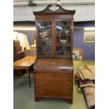 Edwardian cross banded mahogany cyclinder top bureau bookcase with a fitted maple interior above a