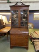 Edwardian cross banded mahogany cyclinder top bureau bookcase with a fitted maple interior above a