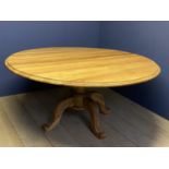 Good Quality light oak circular dining table, moulded edging with dropped flaps on a heavy turned