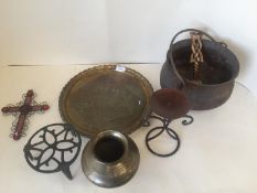 An engraved oriental bronze urn, a C19th cast iron cauldron, an oriental beaten brass tray, a
