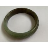 C19th Chinese Spinach Jade bangle with carving of Chinese Calligraphy to exterior 9cm diam