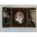 Oval miniature of a boy in leather travelling frame . Signed M Carhill 1897 Condition very worn
