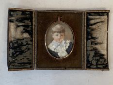 Oval miniature of a boy in leather travelling frame . Signed M Carhill 1897 Condition very worn