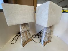 Pair of heavily carved wooden table lamps with rectangular canvas shades CONDITION: some wear -