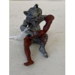 Small cold painted bronze of a Asian seated man smoking a pipe. 6cm H CONDITION: General minor wear