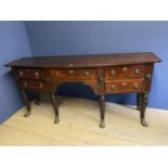 Early C19th mahogany bow front sideboard in the style of Thomas Hope, of 5 drawers with Lion mask