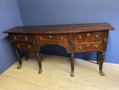 Early C19th mahogany bow front sideboard in the style of Thomas Hope, of 5 drawers with Lion mask