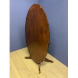 George III oval tilt top cross banded mahogany breakfast table, on a quadruped swept base to