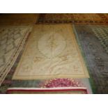 Small Aubusson rug, soft oatmeal ground with soft colours of an oval of leaves, floral panels and