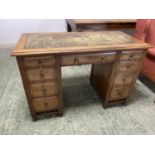 Small mahogany desk of 9 drawers, green tooled leather top 113cmW x 56D x 74cmH (condition: