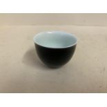 Chinese black ceramic tea bowl, Chinese marks to base, 7cm diameter,