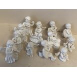 13 pieces of Blanc de Chine winged angels including 4 musicians , 2 seated on boxes and 5 others