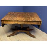 Regency Rosewood sofa table on a quadram base with brass lion paw feet with a drawer to either