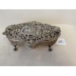 Good quality white metal pierced serpentine casket with hinged lid on 4 claw feet 19 cm L The