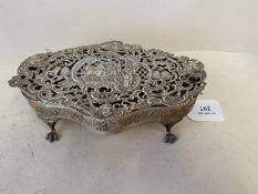 Good quality white metal pierced serpentine casket with hinged lid on 4 claw feet 19 cm L The